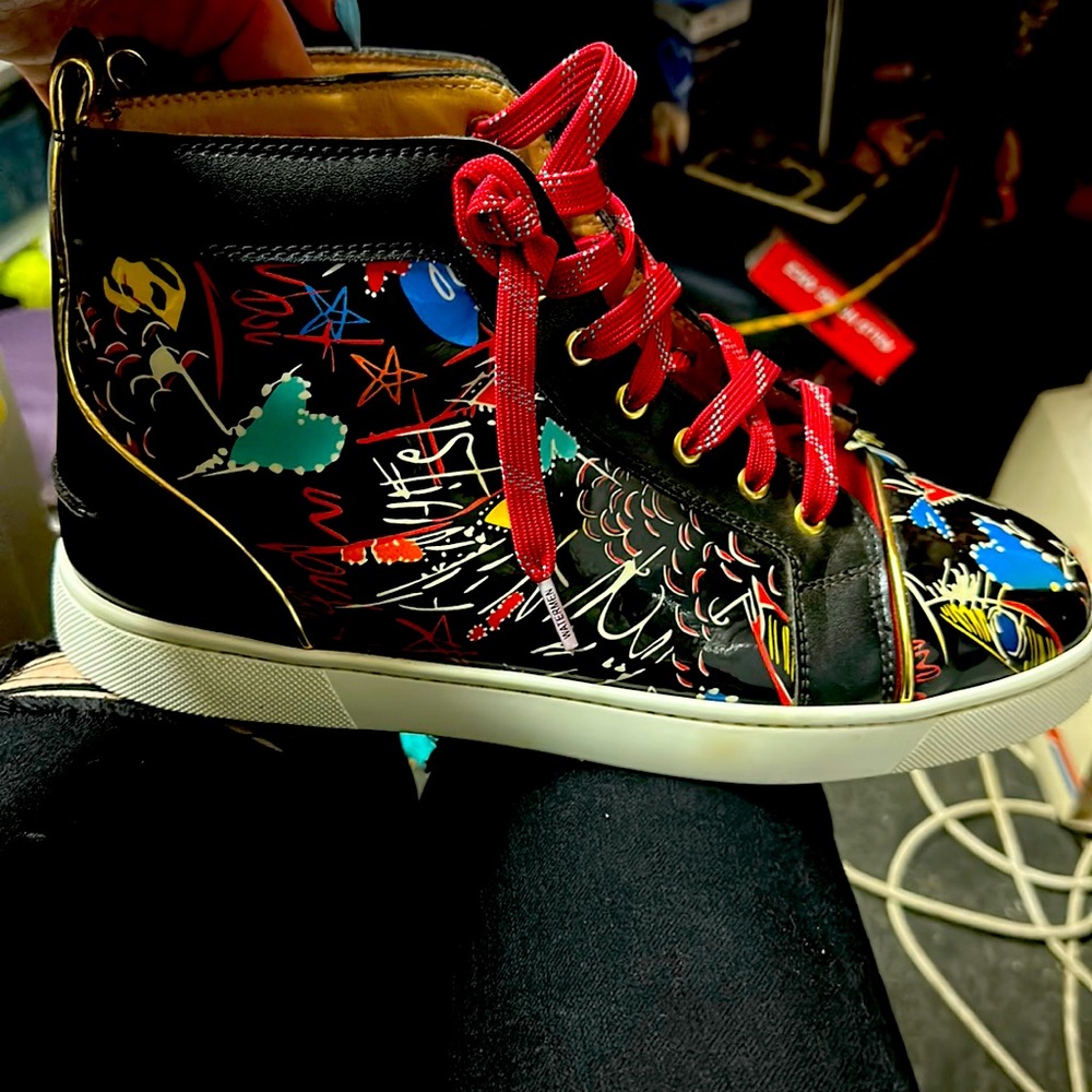 Christian Louboutin black patent sneakers.